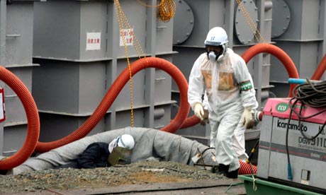 A Tepco employee in protective clothing works around water tanks at the Fukushima nuclear power plant in June. Photograph: Noboru Hashimoto/EPA