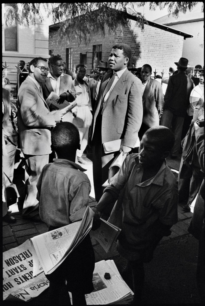 Mandela, then acting as a defense lawyer, outside the Drill Hall during the Treason Trial, the first major trial for treason in Johannesburg, South Africa. 1961. Photograph by Ian Berry/Magnum.