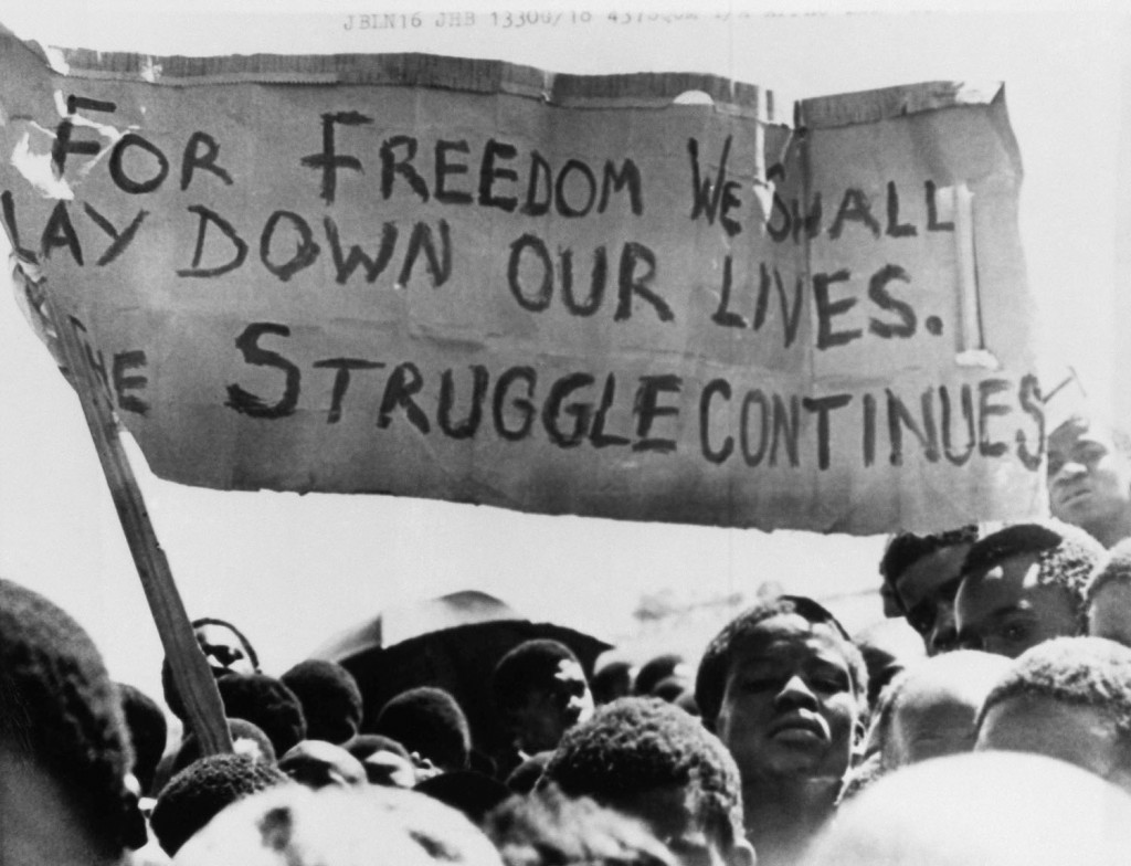 Black students rally in the Soweto township after the funeral of Dumisani Mbatha, a sixteen-year-old student who died in jail after being arrested at a protest march, in 1976. Photograph: AP.