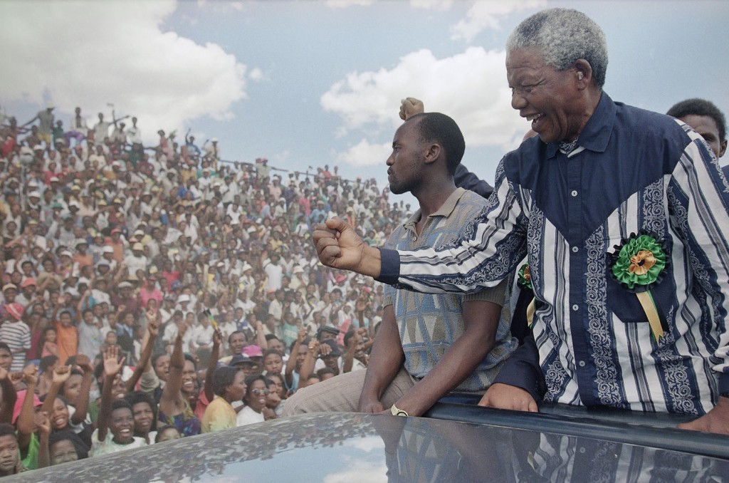 Mandela salutes the crowd in Galeshewe Stadium, near Kimberley, South Africa, on February 25, 1994, during a three-day campaign swing for the April all-race general election. Photograph by David Brauchli/AP.