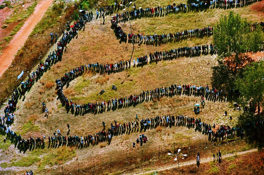 Long lines of people queuing outside the polling station in the black township of Soweto, then a southwest suburb of Johannesburg, South Africa, on April 27, 1994. Photograph by Denis Farrell/AP.