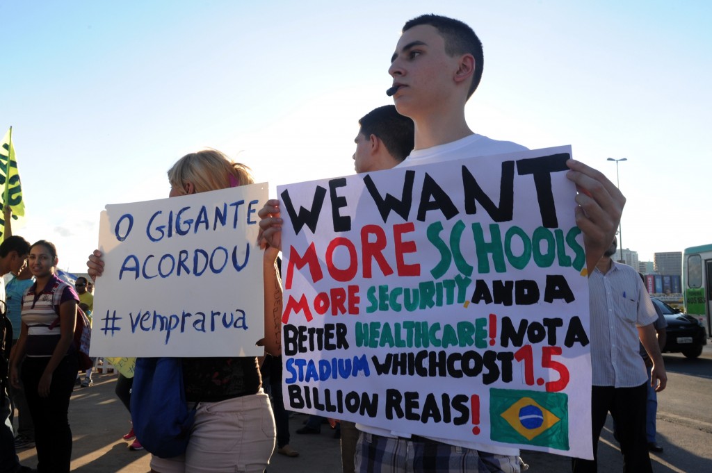 Students hold signs during a protest demanding better public services and criticizing massive government spending on the World Cup. Pinto said he was disappointed by the lack of Afro-Brazilian participation in the World Cup protests, which were largely led by light-skinned, middle-class residents. (Evaristo Sa/Getty Images) 