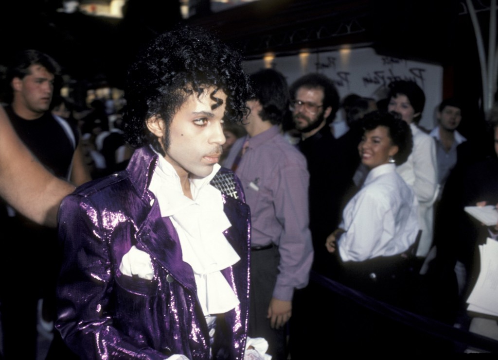 Prince at the premiere of Purple Rain in Hollywood on July 27, 1984: he arrived in a purple stretch limo and, flanked by beefy bodyguards, sashayed down the carpet carrying a single rose