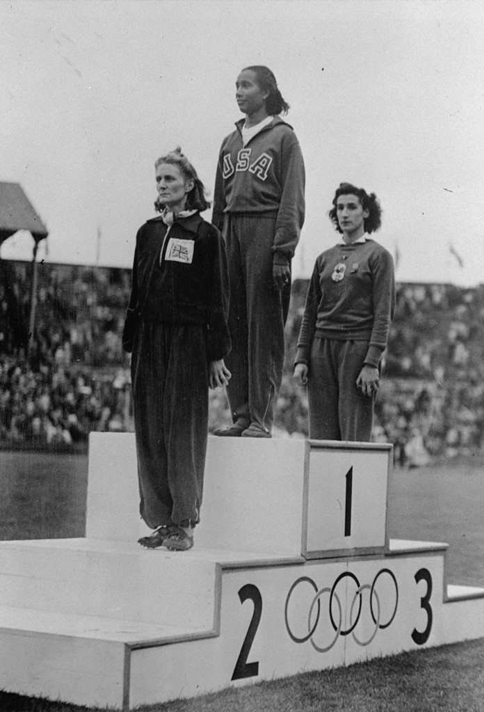 Alice Coachman stands on the winner's section of the Olympic podium at Wembley Stadium in 1948. AP