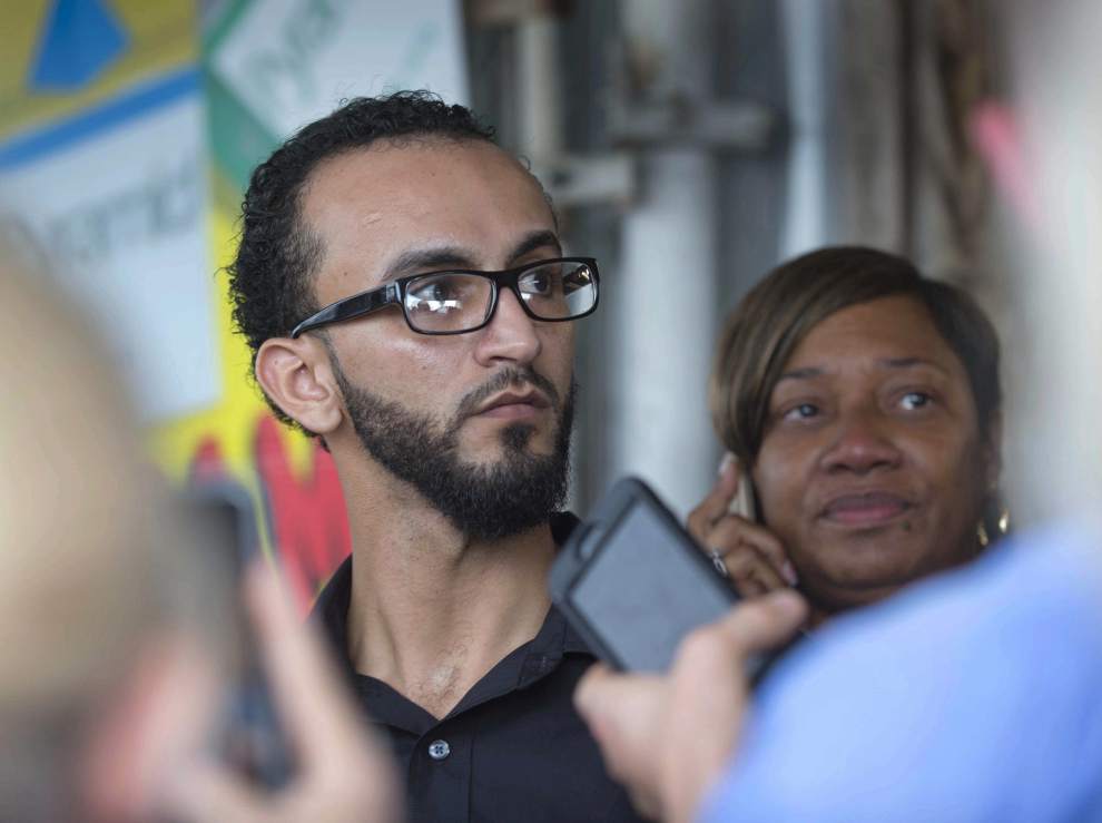 State Rep. C. Denise Marcelle, right, D-Baton Rouge, stands outside Triple S Food Mart with Abdullah Muflahi, the owner and manager of the store in Baton Rouge, La., Wednesday, July 6, 2016. Alton Sterling was shot and killed during a scuffle with police officers outside the store Tuesday, Muflahi said Sterling was not holding a gun during the shooting but that he saw officers remove one from his pocket afterward. (Travis Sprawling/The Advocate via AP) org emit: labat203