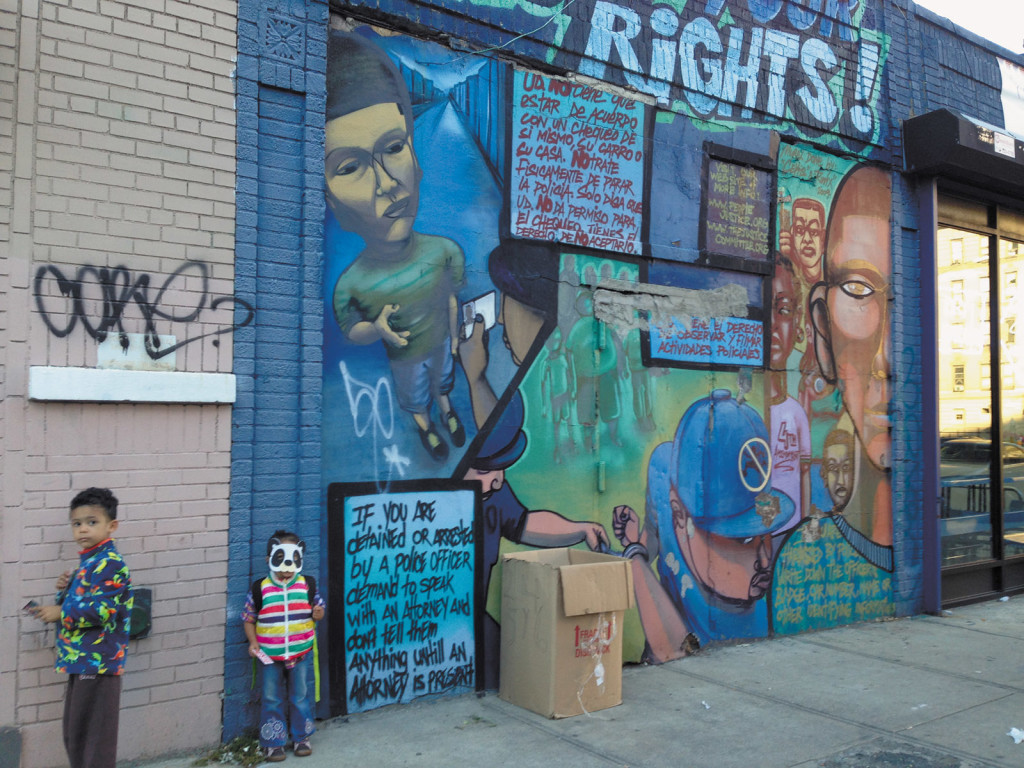 Emily Raboteau   ‘Know Your Rights!’; mural by Nelson Rivas, aka Cekis, Washington Heights, Upper Manhattan. Commissioned in 2009 by the People’s Justice for Community Control and Police Accountability, it has since been painted over. ‘The mural struck me as an act of love for the people who would pass it by,’ Emily Raboteau writes in her essay in The Fire This Time, and ‘as a kind of answer to the question that had been troubling us—how to inform our children about the harassment they might face.’