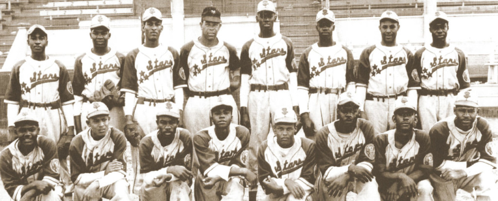 Team photo of the 1950 ManDak League champions, the Winnipeg Buffaloes. Manager Willie Wells is seated to the right of owner Stanley Zeed (first row, third from the left). Leon Day is seated on the far left of the middle row. (Jay-Dell Mah Collection, courtesy of Tazena Kennedy)