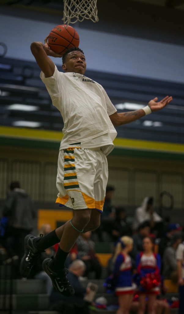 Clover Park High School basketball player Semaj Booker goes up for a basket before playing in the Clover Park Warrior’s playoff game against the Washington Patriots at Foss High School in Tacoma, WA, Monday, February 15, 2016. (Ellen M. Banner / The Seattle Times)